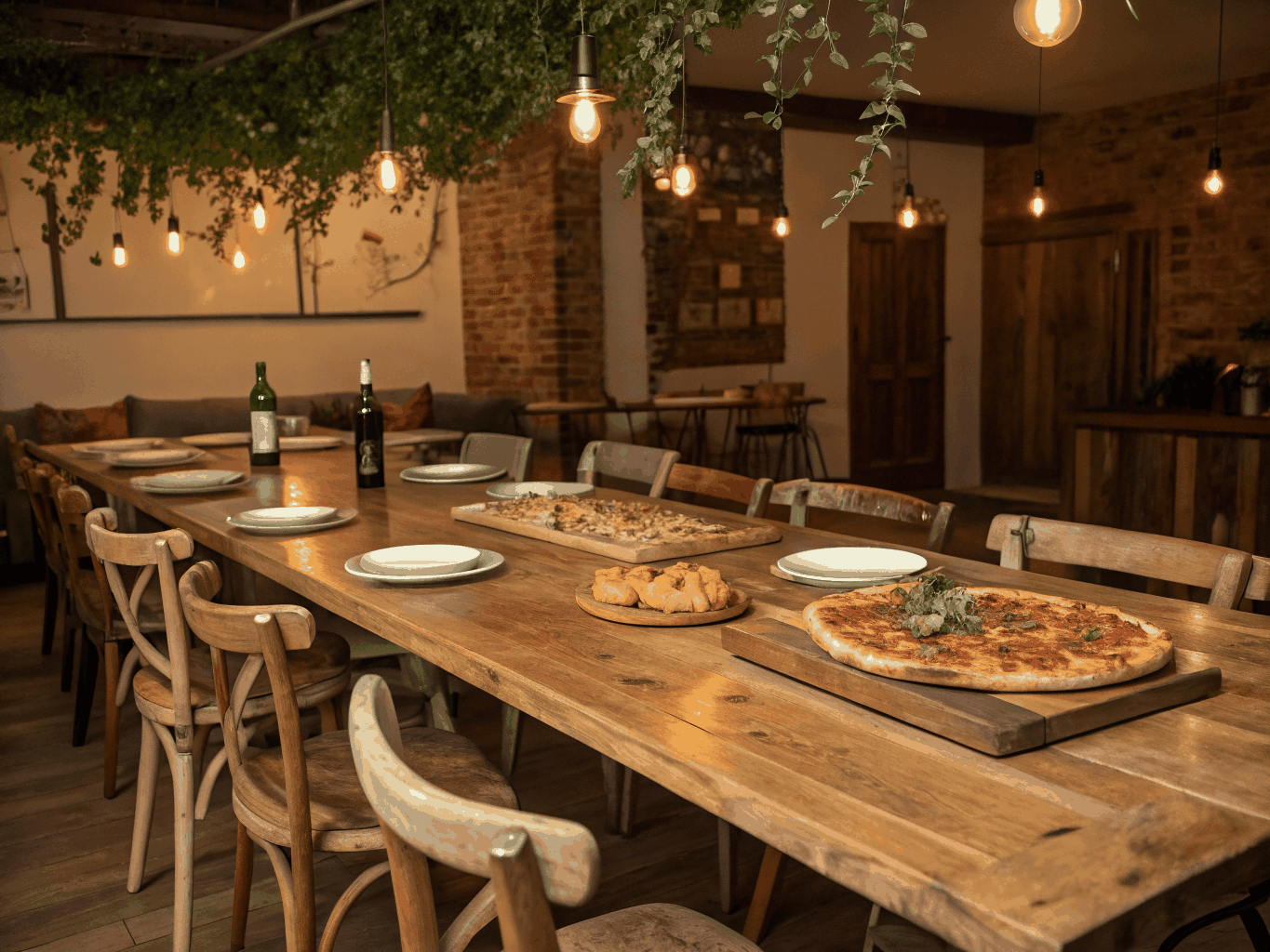 Artisan restaurant dining table setting with fresh culinary dishes and warm hospitality lighting
