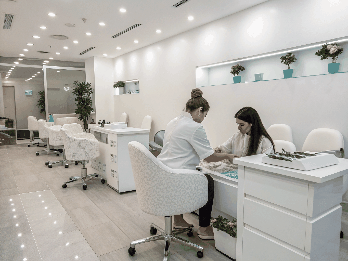 Bright aesthetic nail studio interior with modern manicure stations and clean design